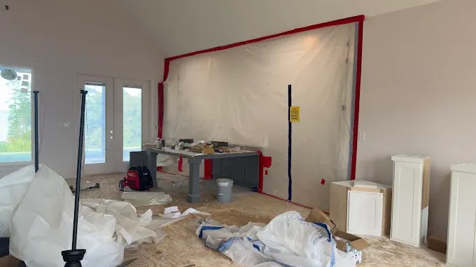 Plastic containment sheeting around an interior work area